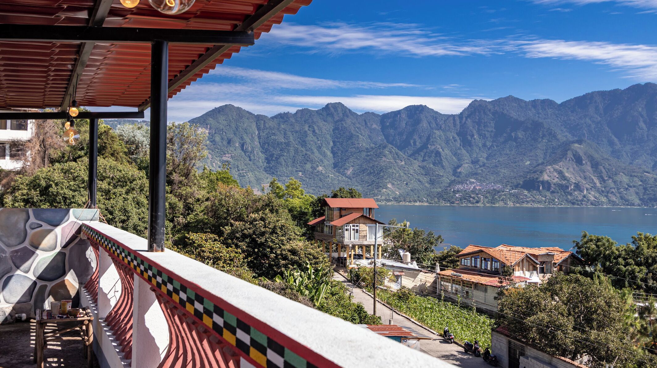 A balcony with a view of a lake and mountains.