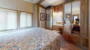 A bedroom with a bed, a desk, and a wardrobe. - #244 Tiger Run (Breckenridge)