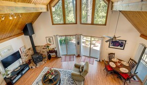High-angle view of the living and dining area with vaulted ceilings and outdoor deck access. - Pine Mountain Lake Cabin & 26 Miles to Yosemite (Groveland)
