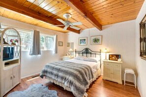 Bedroom featuring a wood-plank ceiling with beams, beadboard walls, and a wrought-iron bed. - Pine Mountain Lake Cabin & 26 Miles to Yosemite (Groveland)