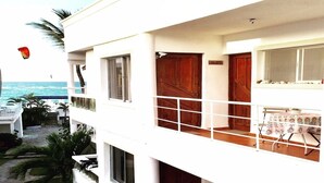 A two-story building with a balcony overlooking a beach. - Charming loft by the sea KiteBeach Condo ByLucia (kite beach)