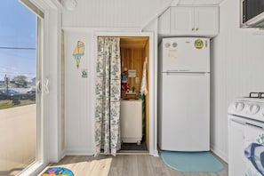 Eine kleine Küche mit Kühlschrank, Herd und Spüle.