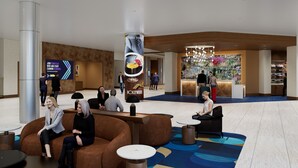 Eine geräumige Lobby mit Sitzbereichen, einem Empfangstresen und einer großen vertikalen Werbeanzeige.