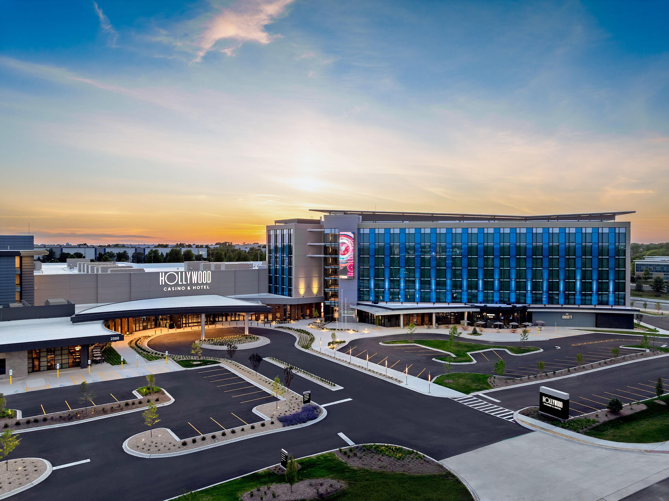 A modern hotel with a large parking lot and a casino.