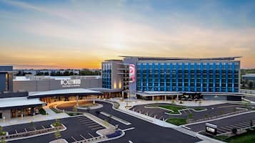A modern hotel with a large parking lot and a casino.