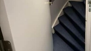 A staircase with dark carpeted steps and a white handrail. - Vermeer - luxury authentic room at Museumplein (Amsterdam)