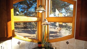A kitchen with two sinks, wooden cabinets, a window with a view of the outdoors, and pendant lights. - Unbeatable 🏔️  Views, Serene, Fall Foliage, Hike, ATV Access (South Fork)