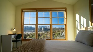 A bedroom with a large window, a bed, a desk, and a chair. - Unbeatable 🏔️  Views, Serene, Fall Foliage, Hike, ATV Access (South Fork)