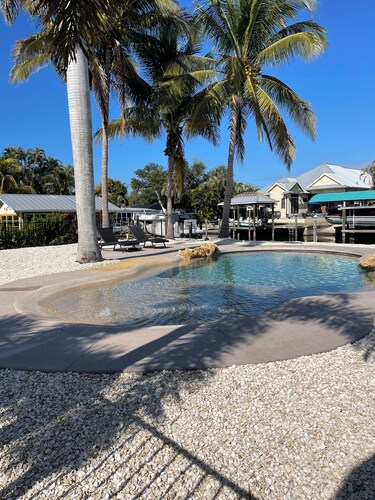 Pine Island bungalow with pool and boat dock…sleeps 4 and optional RV hook-up!