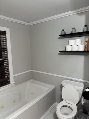 Een douche, handdoeken, zeep, toiletpapier