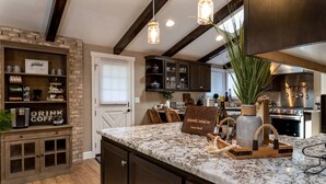 A kitchen with a marble countertop, a guest book, and a sign that reads "Jacksonville Creekside Inn." - Jacksonville Creekside Inn (Jacksonville)