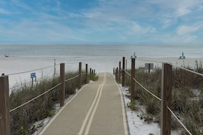 A sandy beach path leading to the ocean with a sign indicating a parking area. - Sea-Esta - Short Walk to Beach, Breezy Balcony, Resort Pool & Snowbirds Welcome (Pensacola)