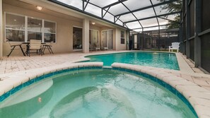 A swimming pool with a glass-enclosed patio area, outdoor seating, and a covered section. - Cw7705 Windsor Hills Resort Vacation Private Pool Home (Kissimmee)