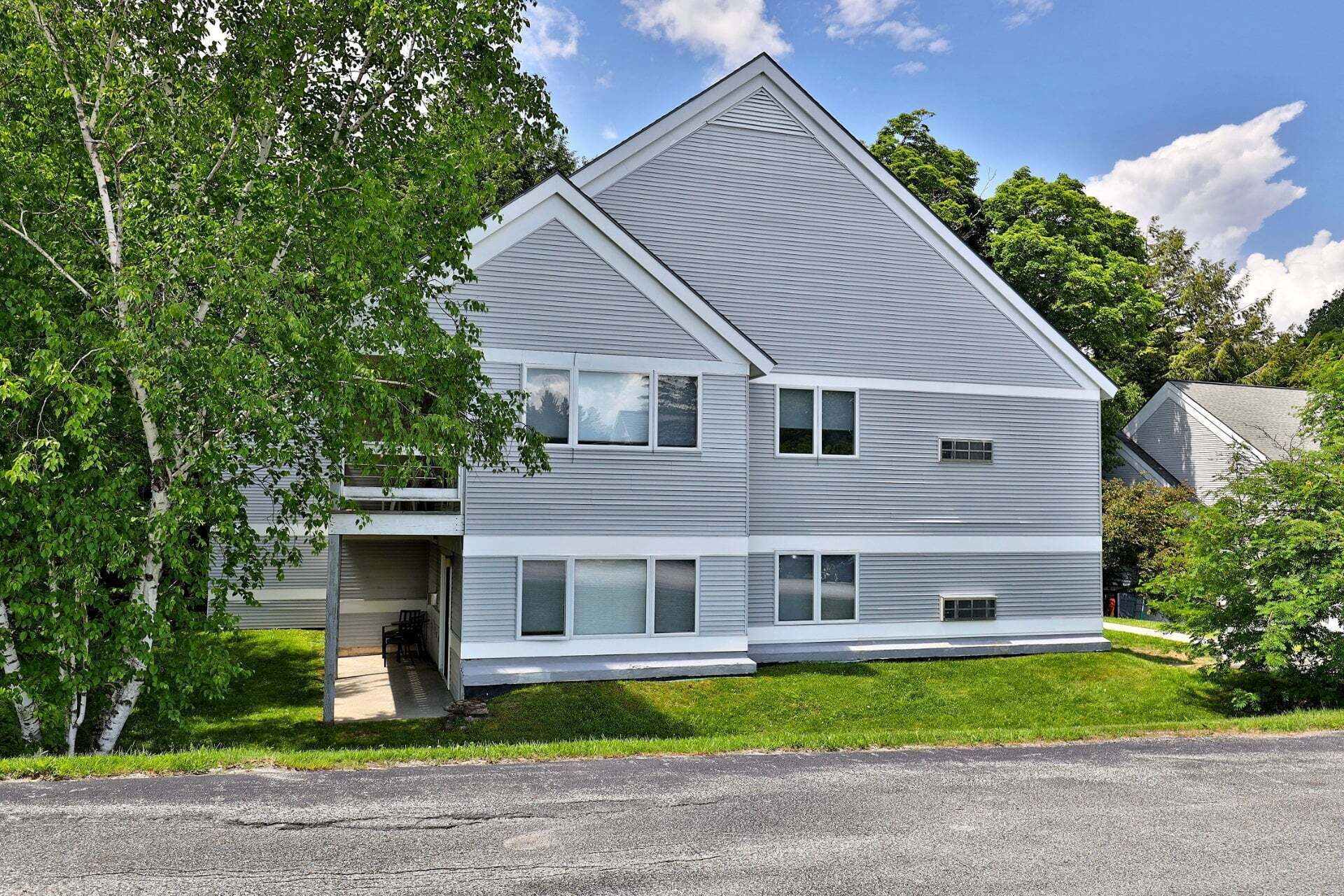 A two-story house with a front porch, a garage, and a driveway.