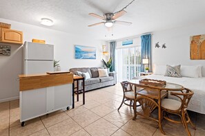 A compact living space with a kitchenette, a dining area, and a bedroom. - Cape Canaveral Studio Condo: Private Balcony, Pool Access, Spa‑Like Sauna & Walk to Beach! ☀️ (Cape Canaveral)