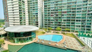 A modern hotel with multiple high-rise buildings, a central pool area, and a circular glass structure. - Palazio Mount Austin by Stayrene  (Johor Bahru)