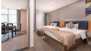 A hotel room with a large bed, a desk with a chair, and a window with curtains. - suzhouzhexujiajiudian (Suzhou)