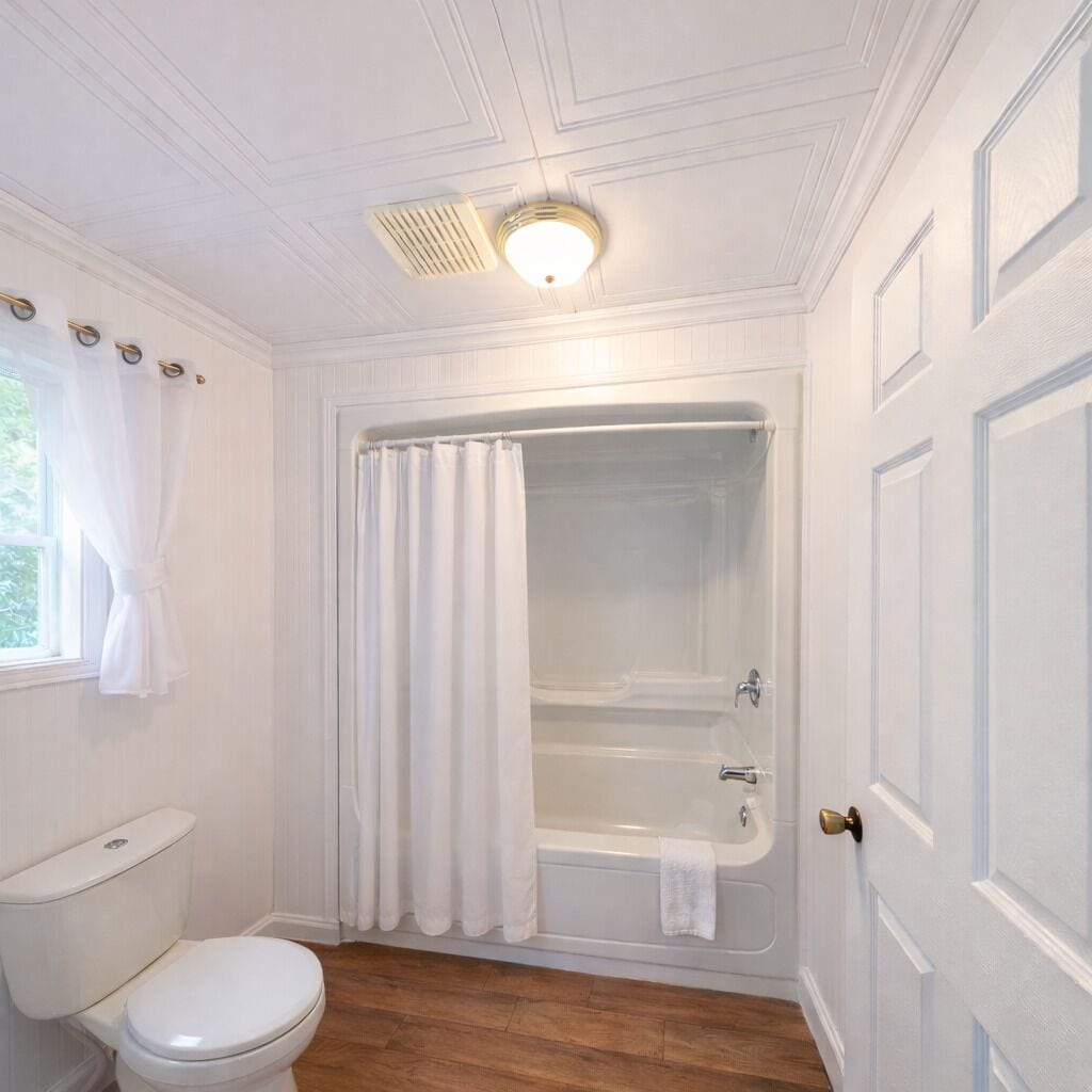 A bathroom with a toilet, a bathtub, and a shower curtain.