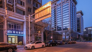 A hotel with a modern facade, large windows, and a prominent sign. - XiYuan Hotel (Beijing)