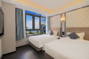 A hotel room with two beds, a large window with curtains, a wall-mounted lamp, and a view of a cityscape. - XiYuan Hotel (Beijing)