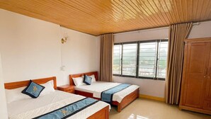 A hotel room with two beds, a wooden ceiling, a window with curtains, and a wardrobe. - Minh Duc 2 Hotel (Trung Khanh)
