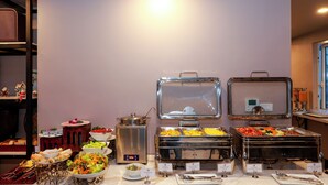 A buffet with various food options and utensils. - ACE Hostel  (Hanoi)
