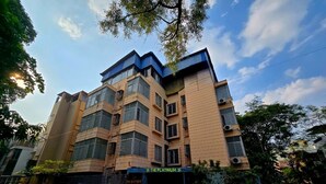 A multi-story building with a modern architectural design, featuring a prominent entrance with a sign. - The Platinum saltlake (Bidhannagar)