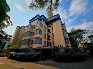 A multi-story building with a modern architectural design, featuring a prominent entrance with a sign. - The Platinum saltlake (Bidhannagar)
