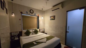 A bedroom with a bed, a ceiling fan, a door, and a wall-mounted air conditioner. - The Platinum saltlake (Bidhannagar)