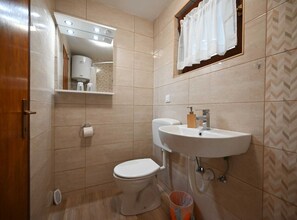A bathroom with a toilet, sink, mirror, and shower. - Calm and Stylish Rooms With Balcony - Studio Apartment With Balcony (Rovinj)