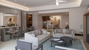 Ein modernes Hotelwohnzimmer mit Essbereich, einer Sofagarnitur, einem Couchtisch und einem Deckenventilator.