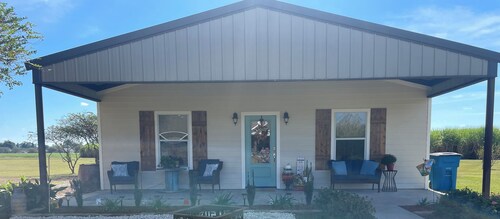 Sugar Cane Cottage is cozy with a country feeling and a big porch.