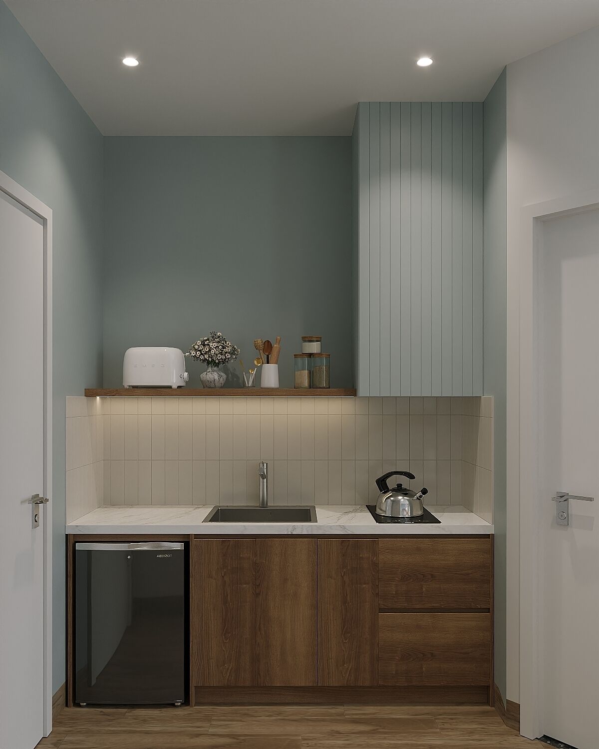 A compact kitchen with a built-in dishwasher, a sink, and a kettle on the countertop.