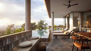A modern outdoor lounge area with a glass infinity pool, wooden furniture, and a view of the landscape.