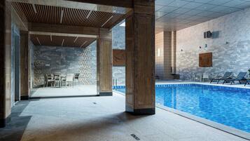 Indoor pool, open 10:00 AM to 10:00 PM, pool loungers