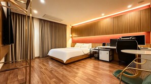 A hotel room with a bed, desk, chair, and a television. - M Place Hotel Guwol-dong (Incheon)