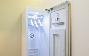 A medical examination room with a patient examination bed, a medical examination table, and a wall-mounted medical device. - M Place Hotel Guwol-dong (Incheon)