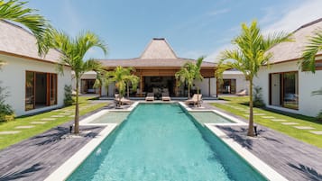 Alberca al aire libre y camastros