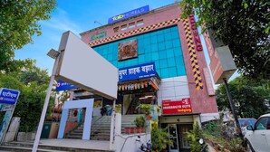 A hotel with a prominent sign for 'Saubhagya Elite Hotel' and a '1ab Hotels' sign above. - Hotel Saubhagya Elite (Nashik)