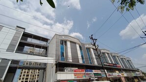 A multi-story building with a prominent sign reading 'GREENLAND STADIUM.' - Surendra Landmark By Spree Hotels (Bhopal)