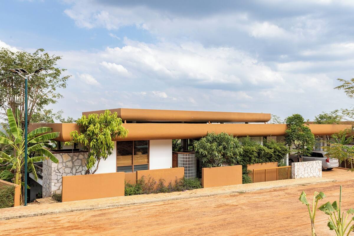A modern house with a flat roof, large windows, and a garage.