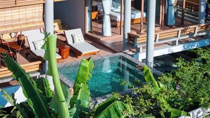 A modern resort with a pool, sun loungers, and a view of the surrounding landscape. - Amaya Kampot (Kampot)