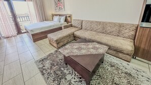 A modern living room with a bed, a sofa, and a coffee table. - Al Dau Heights Apartments (Hurghada)