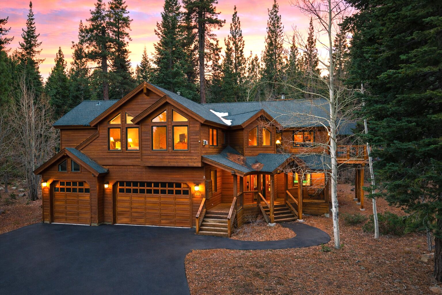 Dusk settles over this Tahoe retreat, where warm lights welcome you home after a day in the mountains.