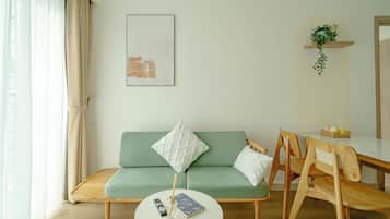 Deluxe Apartment, 1 Bedroom, Balcony, Pool View | Living area | 55-inch LED TV with cable channels, streaming services