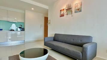 Deluxe Studio, 1 King Bed, Balcony, City View | Living area | Flat-screen TV