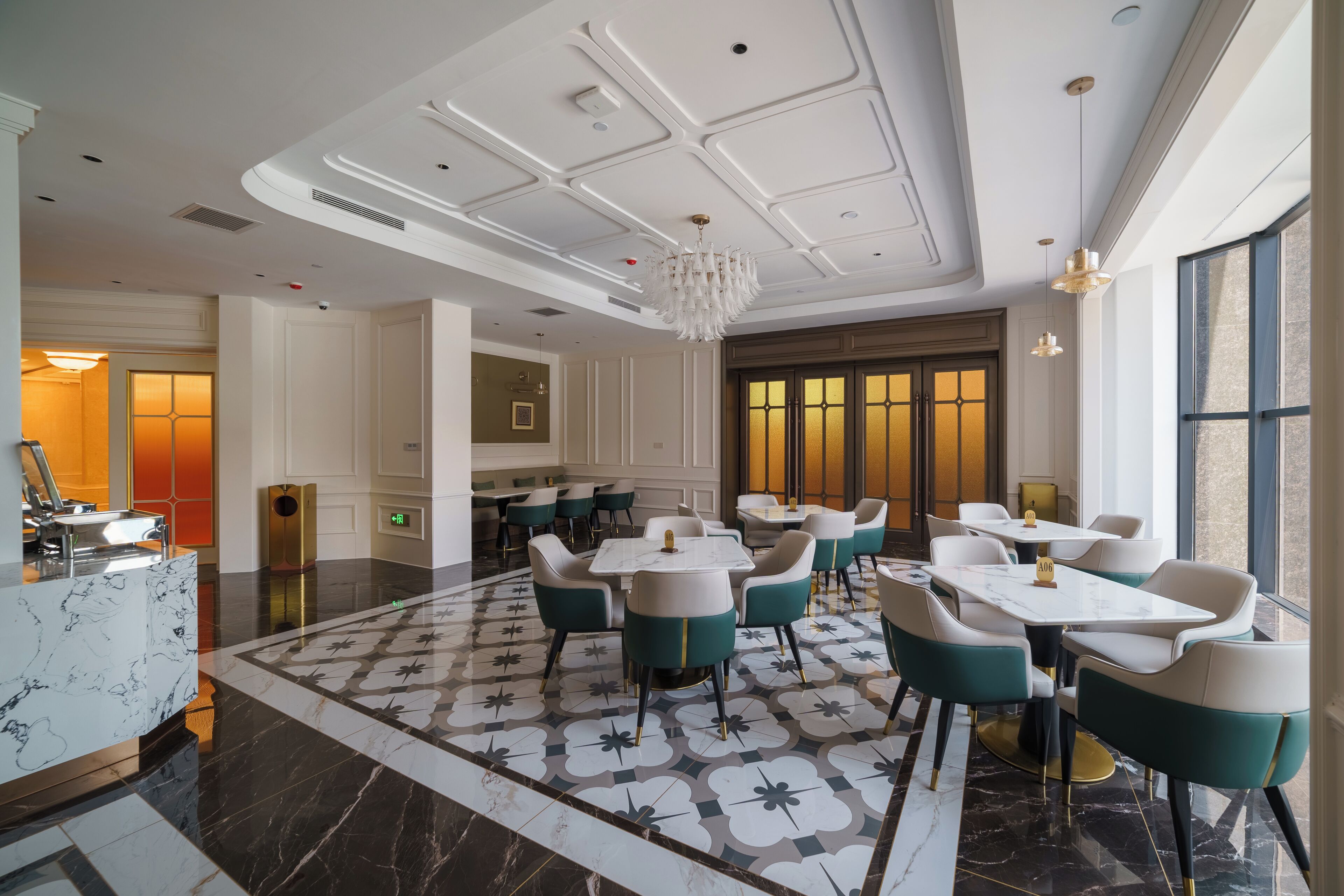 A hotel lobby with a marble floor, a reception desk, and seating areas with tables and chairs.