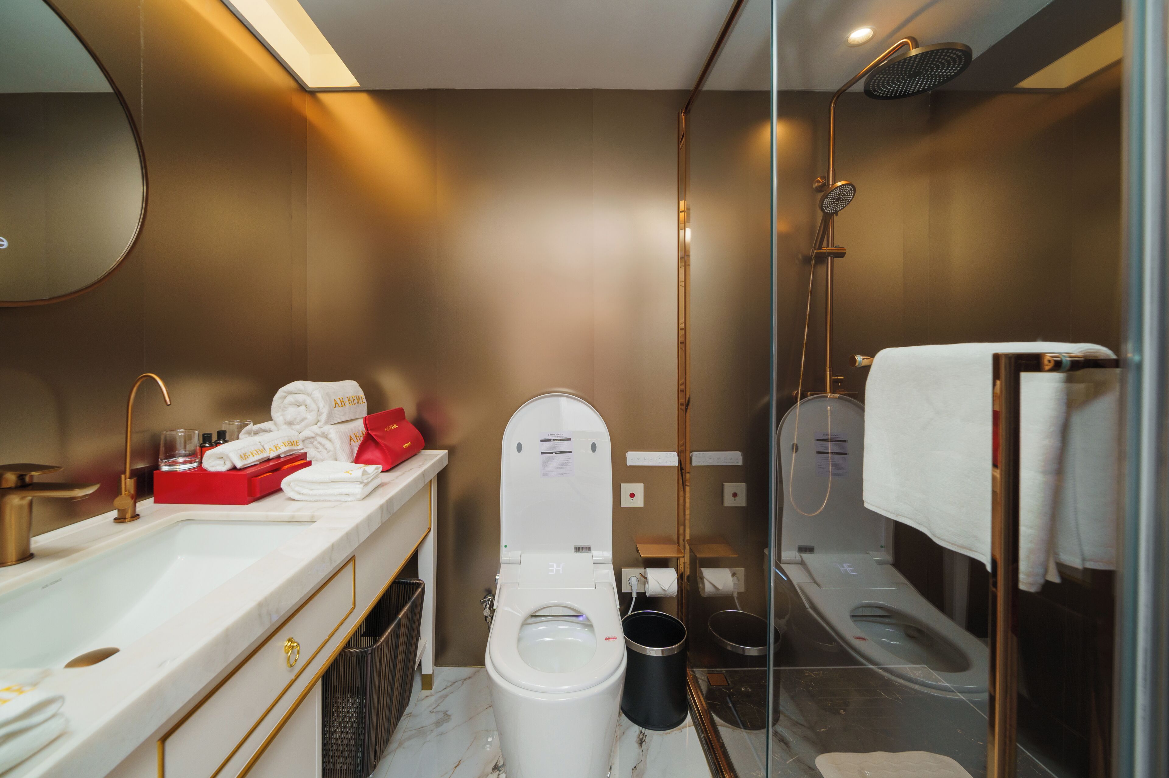 A modern bathroom with a toilet, bidet, and shower.