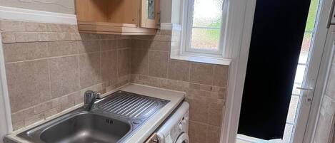 Fridge, stovetop, toaster, cookware/dishes/utensils