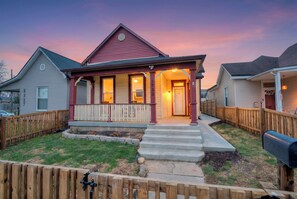 A single-story house with a porch, a front door, and a mailbox.